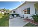 Cozy patio features stylish outdoor furniture, lush plants and beautiful hardscaping at 589 Pond Willow Ln, Venice, FL 34292