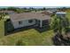 House back view with screened porch and yard at 6297 Drucker Cir, Port Charlotte, FL 33981