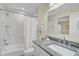 Bathroom with granite countertop, white cabinets, and a shower/tub combo at 6297 Drucker Cir, Port Charlotte, FL 33981