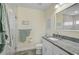 Bathroom with granite countertop, white cabinets, and shower at 6297 Drucker Cir, Port Charlotte, FL 33981