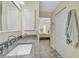 Bathroom with granite countertop, white cabinets, and a bedroom view at 6297 Drucker Cir, Port Charlotte, FL 33981