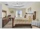 Bedroom with king-size bed, ceiling fan, and dresser at 6297 Drucker Cir, Port Charlotte, FL 33981