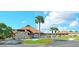 Community clubhouse exterior with palm trees and paved driveway at 6297 Drucker Cir, Port Charlotte, FL 33981