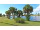 Scenic community lake view with lush landscaping and palm trees at 6297 Drucker Cir, Port Charlotte, FL 33981