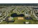 Aerial view of community including tennis courts, pool, and lake at 6297 Drucker Cir, Port Charlotte, FL 33981
