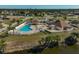Aerial view of community pool, clubhouse, and surrounding landscape at 6297 Drucker Cir, Port Charlotte, FL 33981