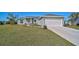 Newly constructed home with a 2-car garage and well-manicured lawn at 6297 Drucker Cir, Port Charlotte, FL 33981