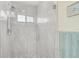 Walk-in shower with pebble-stone floor and glass enclosure at 6297 Drucker Cir, Port Charlotte, FL 33981