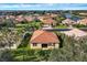 Aerial view showcasing the community with tile roofs and a nearby pond at 6370 Falcon Lair Dr, North Port, FL 34287