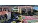 Aerial view of the condo complex with tennis courts and water views at 7102 Jessie Harbor Dr # 7102, Osprey, FL 34229