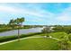 Scenic view of the lake with lush greenery and a walking path at 7102 Jessie Harbor Dr # 7102, Osprey, FL 34229