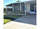 Front view of manufactured home with covered porch and landscaping at 73 Lakeview Dr, North Port, FL 34287