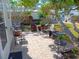 Relaxing patio with wicker furniture, under a large shade tree at 858 S Green Cir, Venice, FL 34285