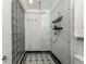 Bathroom with walk-in shower with glass enclosure and tiled walls at 101 Base E Ave # 101 & 103, Venice, FL 34285