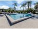 Community pool with palm trees at 1100 Capri Isles Blvd # 221, Venice, FL 34292