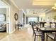 Spacious dining area with a dark wood table, chandelier, and tray ceiling at 1114 Cielo Ct, North Venice, FL 34275