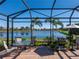 Relaxing screened patio overlooking a lake with lush landscaping at 11301 Bertolini Dr, Venice, FL 34292