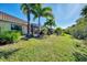 Large backyard with grassy area and screened patio at 11539 Okaloosa Dr, Venice, FL 34293