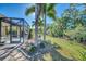 Backyard with screened patio and lush landscaping at 11539 Okaloosa Dr, Venice, FL 34293