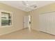 Bright bedroom with tile floors, window shutters, and double doors at 11539 Okaloosa Dr, Venice, FL 34293