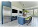 Stylish community kitchen featuring blue cabinetry and a large island at 11539 Okaloosa Dr, Venice, FL 34293