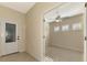 Light and airy entryway with tile floors and a view into an adjacent room at 11539 Okaloosa Dr, Venice, FL 34293