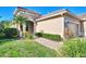 Tan house with tile roof, landscaping, and a two-car garage at 11539 Okaloosa Dr, Venice, FL 34293