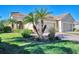 Two-story house with palm trees, lush landscaping, and a paved driveway at 11539 Okaloosa Dr, Venice, FL 34293