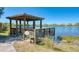 Wooden fishing pier with a gazebo overlooking a lake at 11539 Okaloosa Dr, Venice, FL 34293