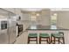 Modern kitchen with white cabinets, stainless steel appliances, and a granite countertop island at 11539 Okaloosa Dr, Venice, FL 34293