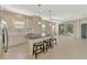 Modern kitchen with white cabinets, granite island, and stainless steel appliances at 11539 Okaloosa Dr, Venice, FL 34293