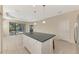 Open kitchen with island and view into adjacent living area at 11539 Okaloosa Dr, Venice, FL 34293