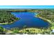 Serene lakefront view with walking path and lush landscaping at 11539 Okaloosa Dr, Venice, FL 34293
