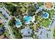 Aerial view of community pool and clubhouse with surrounding green space at 11539 Okaloosa Dr, Venice, FL 34293