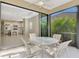 Screened patio with view into kitchen and backyard at 11539 Okaloosa Dr, Venice, FL 34293