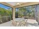 Screened patio with table and chairs, overlooking the backyard at 11539 Okaloosa Dr, Venice, FL 34293