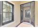 Covered entryway with a screened door and window with white plantation shutters at 11539 Okaloosa Dr, Venice, FL 34293
