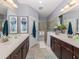 Elegant bathroom with double vanity and walk-in shower at 1195 Collier Pl, Venice, FL 34293