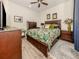 Bright bedroom featuring a queen-size bed and wood furniture at 1195 Collier Pl, Venice, FL 34293