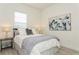 Cozy bedroom featuring a queen-size bed and large art piece at 12472 Meribel St, Venice, FL 34293