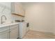 Functional laundry room with washer, dryer, and cabinets at 12472 Meribel St, Venice, FL 34293