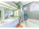 Double vanity bathroom with a large soaking tub and separate shower at 125 Amora Ave, Venice, FL 34285