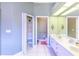 Clean bathroom with double vanity and linen closet at 125 Amora Ave, Venice, FL 34285