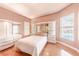 Bright bedroom with hardwood floors, large windows, and built-in shelving at 125 Amora Ave, Venice, FL 34285