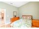 Bedroom with light walls, wood flooring, and a leafy patterned bedspread at 125 Amora Ave, Venice, FL 34285