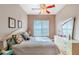 Spacious bedroom with ceiling fan and large dresser at 125 Amora Ave, Venice, FL 34285