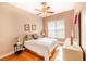 Bedroom with wood flooring and a ceiling fan, offering natural light at 125 Amora Ave, Venice, FL 34285