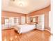 Spacious bedroom with hardwood floors and built-in mirrored wardrobe at 125 Amora Ave, Venice, FL 34285