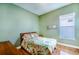 Bright bedroom with wood floors and leafy bedding at 125 Amora Ave, Venice, FL 34285