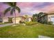 Well-maintained house with a charming facade and manicured lawn at 125 Amora Ave, Venice, FL 34285